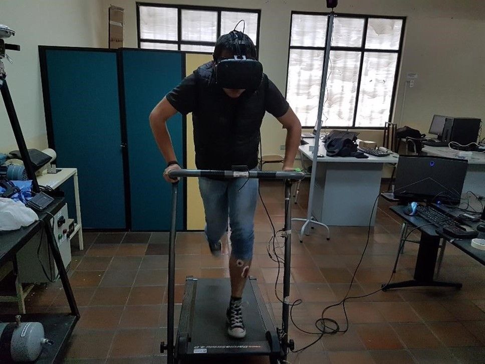 A person wearing a VR headset runs on a treadmill in a lab